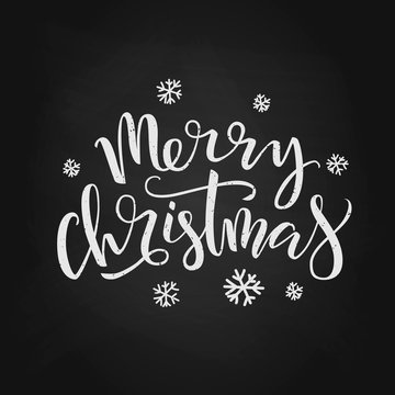 Hand drawn Merry Christmas lettering typography poster. Celebration quote on chalkboard background for postcard, icon, logo, badge. Vector calligraphy text on a dark background