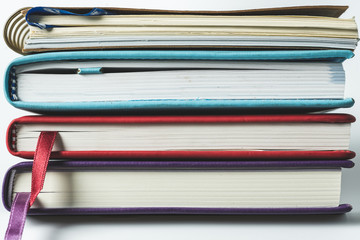 Close up stack of books on white background