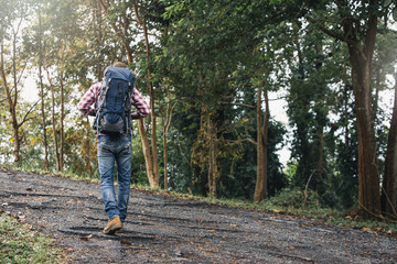 Fototapeta premium Man traveling with backpack hiking in mountains. Man backpacker hiking in mountains alone outdoor active lifestyle travel adventure vacations.
