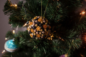 Beautiful toy on a Christmas tree. Winter holiday. Decorated Christmas tree in the bedroom. Lifestyle.
