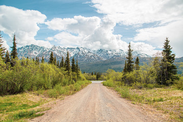 Scenic dirt road with mountain range in Alaska