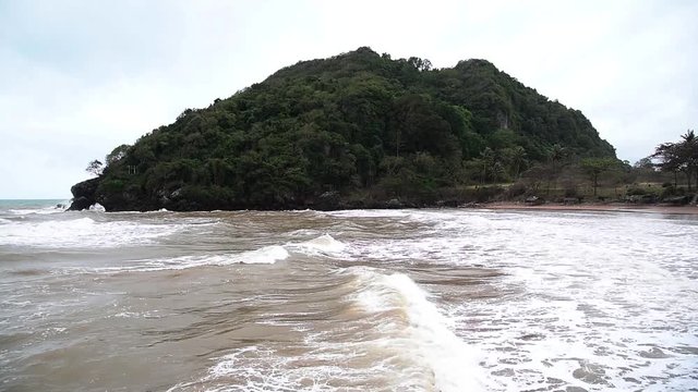 The sea at Bang Berd Beach with mountain in the background, Prachuap Khiri Khan, Thailand