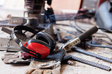 Ear muffs Safety equipment Preventing noise And gloves put on the floor