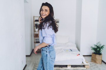 Pretty young woman talking on smartphone and smiling