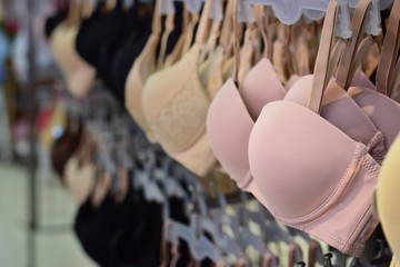 Row of bras in underwear shop blurred background , self confidence and health care concept.
