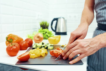 woman cutting vegetables in kitchen