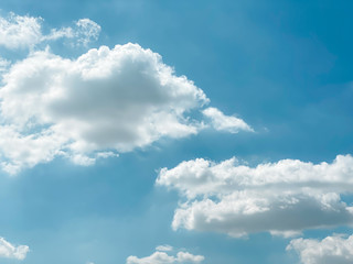 Background of clear blue sky and fluffy cloud  and sun shining during summer season. 