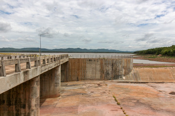 The dam crest the concrete spillway. countryside blocks the river to store water for agriculture and consumption