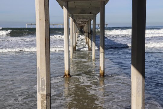 High tide underneath Ocean Beach Pier pillons
