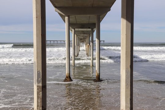 High tide underneath Ocean Beach Pier pillons