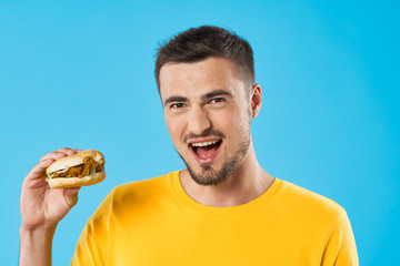young man eating hamburger