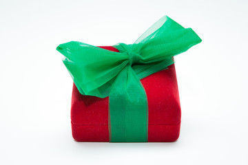 Red gift box with green ribbon  on a white background