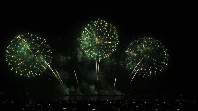 Real fireworks background and people who come to watch on the beach Pattaya International Fireworks Festival. New year's eve fireworks celebration Asia Thailand