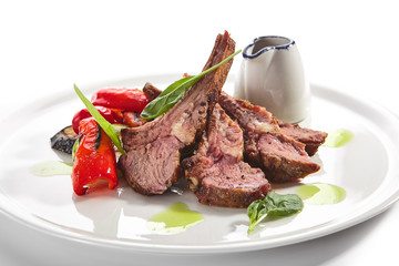 Grilled Lamb Rack with Baked Vegetables on White Restaurant Plate