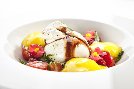 Exquisite serving burrata cheese with tomatoes and mango mousse