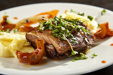 Beef brisket and mashed potato on white plate