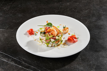 Olivier salad with crab meat and shrimps on white plate