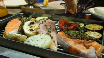 Grilled fish, grilled salmon steak, chicken, aromatic spices and grilled vegetables steak, season with lemon, close-up, 4k.