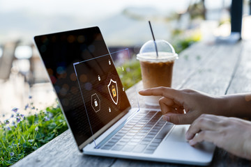 Businessman using a laptop computer with technology cybersecurity and privacy concept. protection and safe data for global network security.