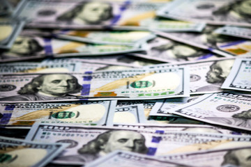 Blurred closeup of hundred dollars background