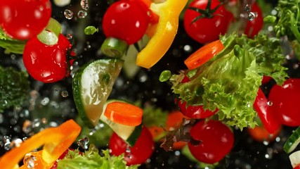 Super Slow Motion Shot of Flying Cuts of Colorful Vegetables and Water Drops on Black background at 1000fps. - Powered by Adobe