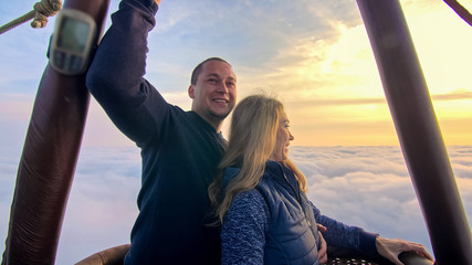 Adventure love couple on hot air balloon watermelon. Man and woman kiss hug love each other. Burner...