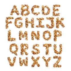  English alphabet from a mixture of hazelnuts, almonds, walnuts, peanuts, cashews, pumpkin seeds on a white isolated background. Food pattern made from nuts. Bright alphabet for shops.