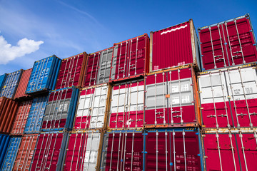 The national flag of Denmark. on a large number of metal containers for storing goods stacked in...