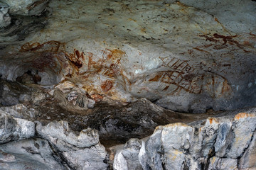 Ancient cave paintings on limestone wall in Phang Nga,Thailand