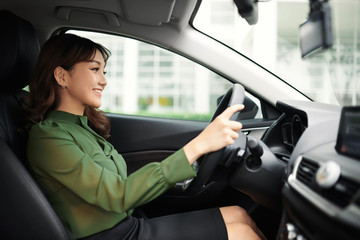 Young beautiful woman driving her car