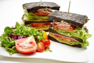 Black bread chicken sandwich with salad 