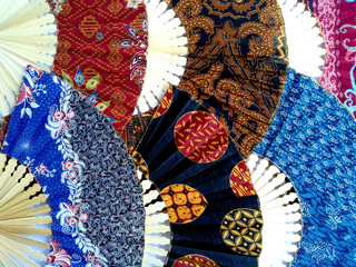 Hand fan from Bali Indonesia. Kipas Tangan Motif Batik or hand fan Batik made of bamboo and batik fabric. Hand fan patterned batik isolated on white background.