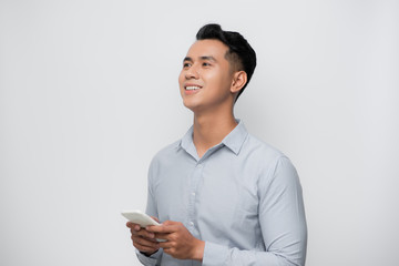 Happy smile face of handsome Asian man use smartphone.
