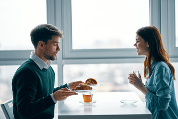 young couple having breakfast in the kitchen
