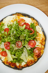Black dough salad pizza with black pepper 