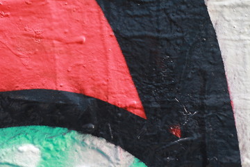 colorful close up details of a city wall covered in Graffiti, red, blue, white and black elements and parts of text and letters, Melbourne Australia