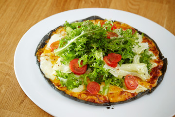 Black dough salad pizza with black pepper 