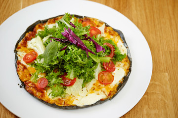 Black dough salad pizza with black pepper 