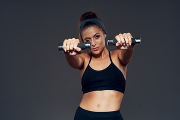 Fototapeta na wymiar young woman exercising with dumbbells