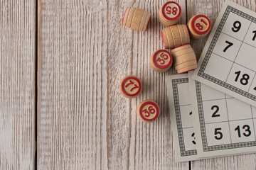 Play bingo or Lotto on a wooden table. Concept of Board games.