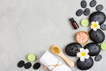 Top view of hot spa stones set for massage treatment on gray concrete background with copy space. Elegant and luxury spa. Flat lay, overhead, mock up, template. Health and beauty care concept