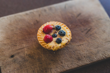 berries custard and chocolate pastries on cutting board