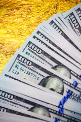 One hundred dollars stack on a gold close-up 3