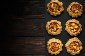 Dumplings with vegetable: Dimsum, Jiaozi, Momo, Ha Gao on dark wood background. Top view, copy text.
