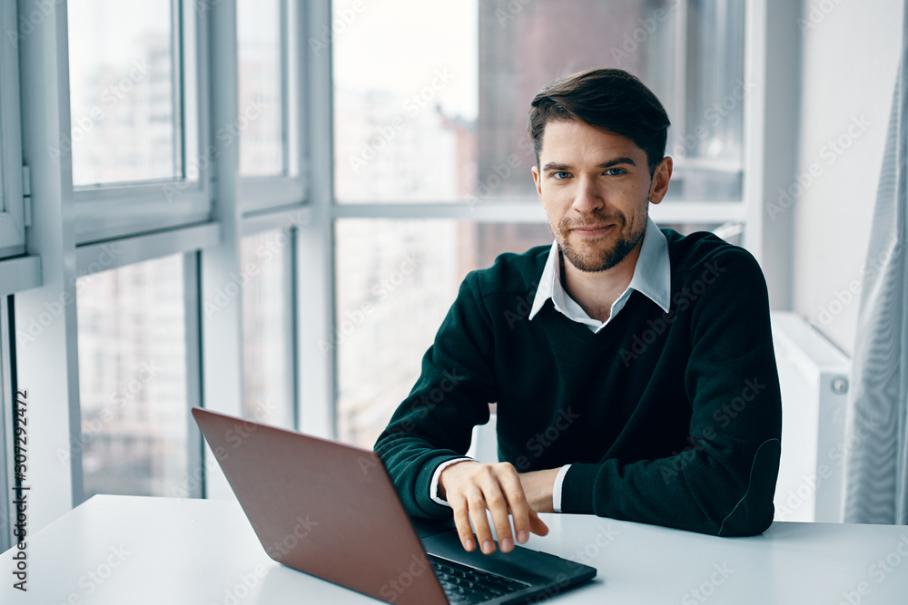 Poster businessman working on laptop in office