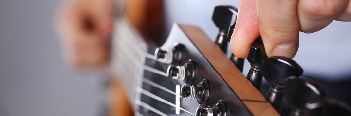 Male arms playing classic shape electric guitar