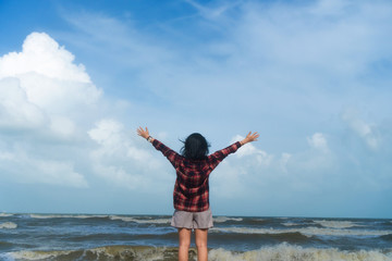 Obraz premium Woman rise hands up to sky freedom concept with blue sky.