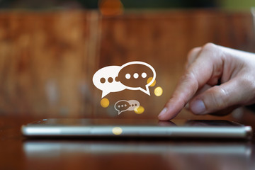 Women hand using smartphone mobile typing, chatting conversation in chat box icons pop up. Social media maketing technology concept.Vintage soft color tone background.