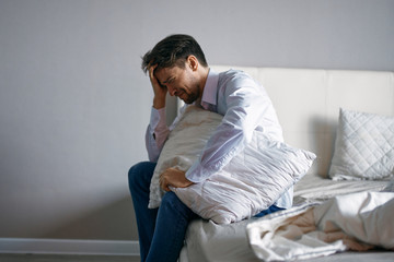 man sitting on sofa and looking at camera