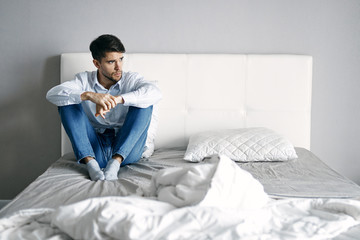 Fototapeta premium man sitting on sofa and using laptop